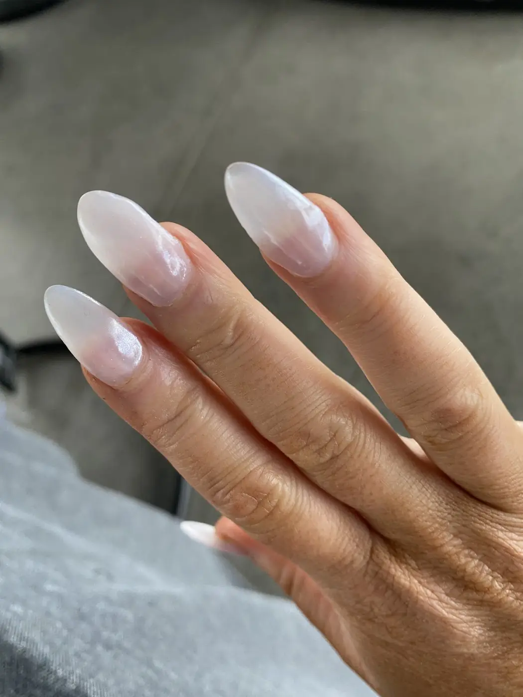 Long almond nails in a soft white ombre