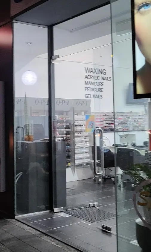 The salon window lettering: waxing, acrylic nails, manicure, pedicure, gel nails, with OPI colour racks inside